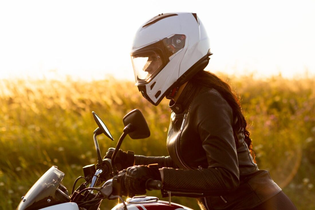 Female motorcycle rider with helmet