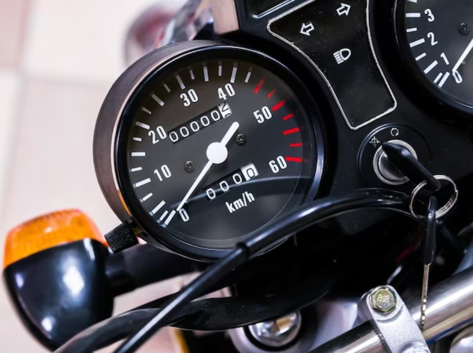 a motorcycle’s speedometer with zero mileage