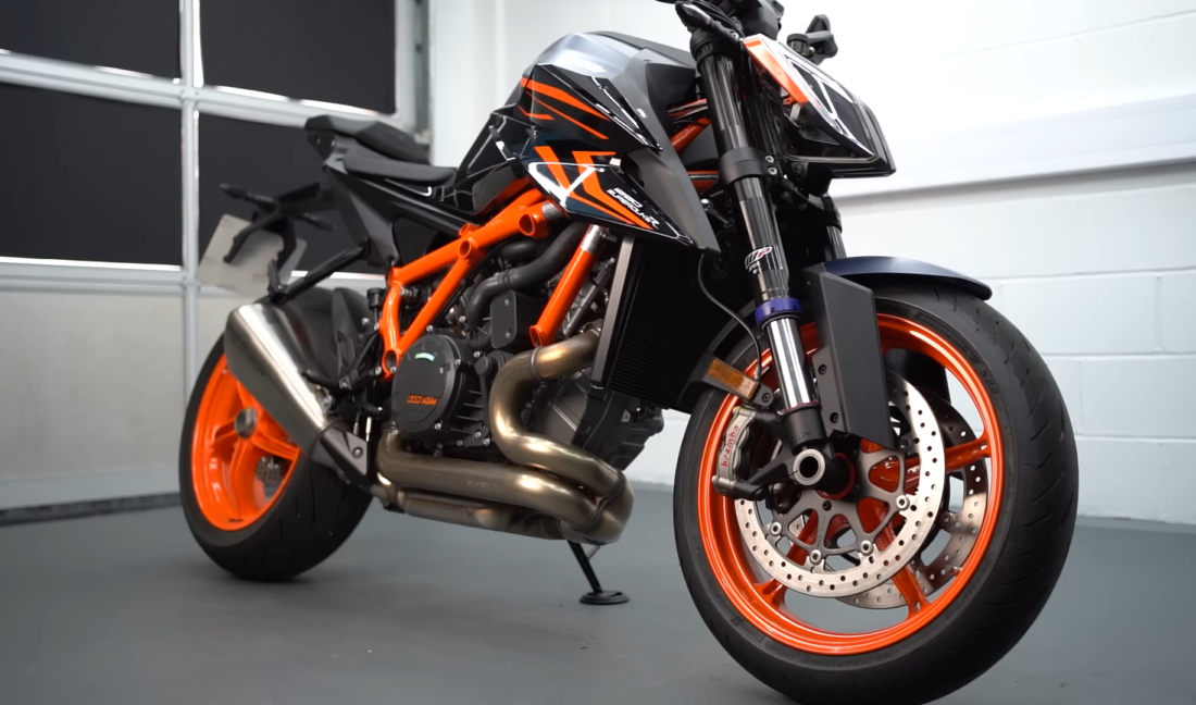 orange and black color bike 1290 Super Duke R Evo in a room near white walls and windows 